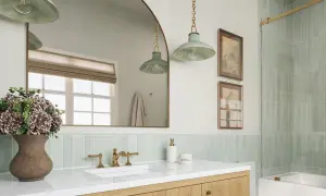 A modern bathroom with a light green vertical tile backsplash placement behind a white sink and vanity.