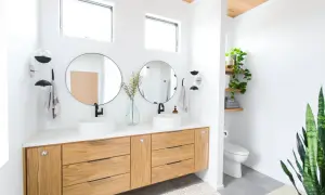 Modern bathroom with dual sinks, wooden vanity, and round mirrors. The bathroom mirror height is ideal for comfortable use.