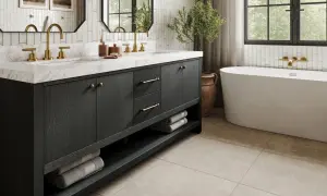 Elegant small bathroom ideas featuring a dark wood vanity with brass hardware, marble countertop, and a freestanding tub.