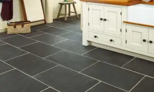 Dark slate tiles with light grout in a kitchen. Learn how to clean slate floors to keep them looking this good.