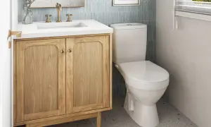 A light wood vanity with brass hardware offers a warm, inviting feel, proving it's the best vanity color for small bathrooms.