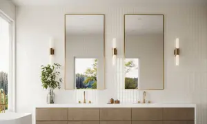 Modern bathroom with vertical subway tile design ideas, featuring a double vanity, gold-framed mirrors, and natural light.