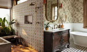 A bathroom with a patterned tile shower wall and timeless bathroom flooring featuring a black and white octagonal tile pattern.