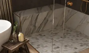 Elegant shower floors with a mosaic tile pattern, complemented by marble walls and a glass enclosure.