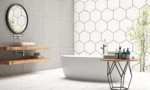 Modern bathroom with a freestanding tub, hexagonal wall tiles, and light-colored floor tiles. Ceramic tile is good for bathroom floors, offering durability and style.