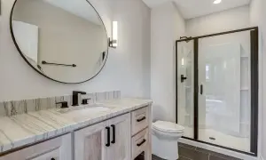 Modern bathroom with a quartzite vanity top. Learn how to clean quartzite to keep this beautiful surface sparkling.