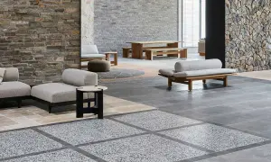 Modern living space with stone walls, wooden furniture, and a striking terrazzo design floor.