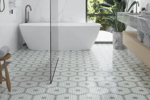 Stylish bathroom with a freestanding tub and a patterned floor. Pictures of shower floors like this one showcase a modern design.