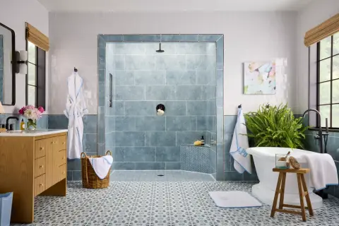 Elegant bathroom featuring a blue marble shower and patterned floor tile combinations.