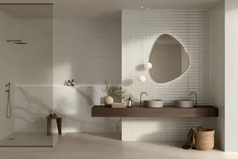 Modern bathroom featuring large format neutral tiles and textured subway tiles, showcasing diverse types of tile for bathroom design.