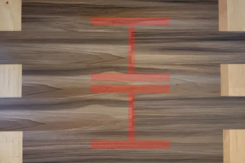 Visual guide on how to install vinyl plank flooring, showing a pattern of wood-look planks with a red overlay indicating installation steps.