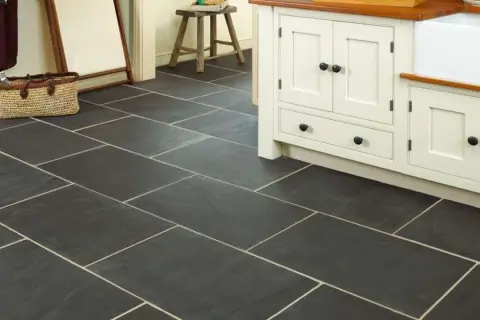 Dark slate tiles with light grout in a kitchen. Learn how to clean slate floors to keep them looking this good.
