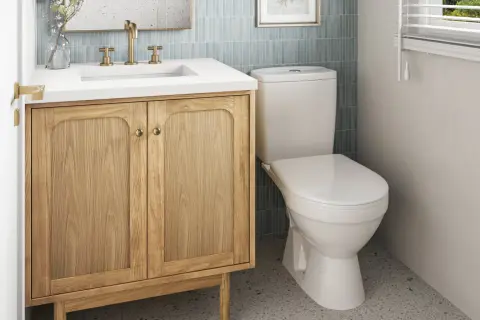 A light wood vanity with brass hardware offers a warm, inviting feel, proving it's the best vanity color for small bathrooms.