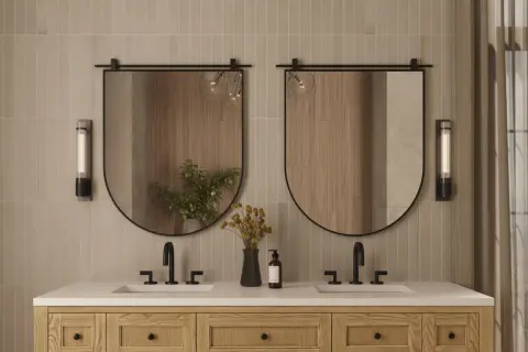 A modern bathroom vanity with two sinks, featuring oval mirrors with a subtle mirror thickness.