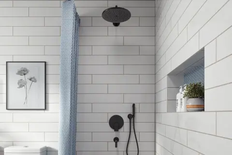 A modern bathroom features white subway tile with light gray grout, a black showerhead, and a patterned shower curtain.