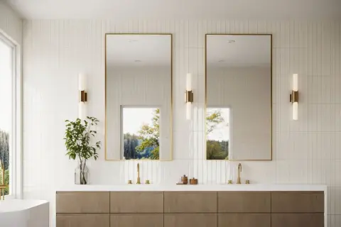 Modern bathroom with vertical subway tile design ideas, featuring a double vanity, gold-framed mirrors, and natural light.