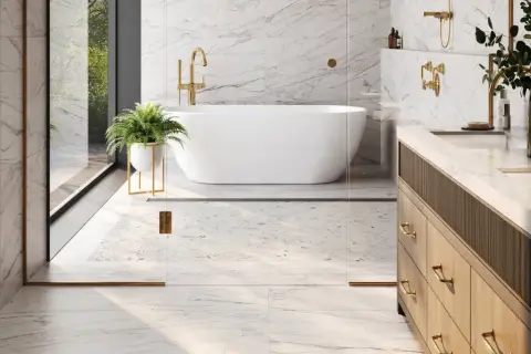 A luxurious bathroom with marble floors, a freestanding tub, and a vanity. This image shows why marble is good for bathroom floors, offering elegance and durability.
