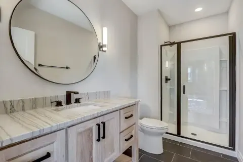 Modern bathroom with a quartzite vanity top. Learn how to clean quartzite to keep this beautiful surface sparkling.