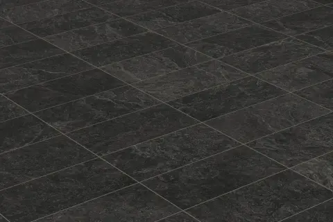 A textured, dark grey tiled floor, perfect for learning how to clean black tiles in the bathroom.