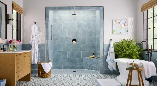 Elegant bathroom featuring a blue marble shower and patterned floor tile combinations.