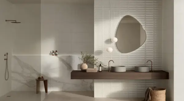 Modern bathroom featuring large format neutral tiles and textured subway tiles, showcasing diverse types of tile for bathroom design.