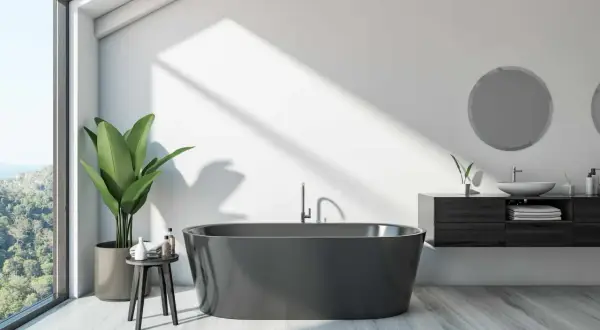 A modern bathroom with a dark grey bathtub, large window, and plant. This image might inspire ideas on how to paint a bathtub for a sleek look.
