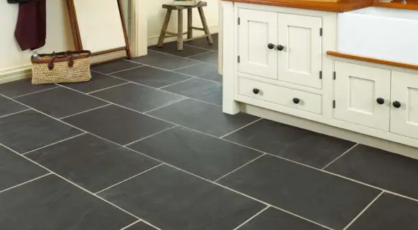 Dark slate tiles with light grout in a kitchen. Learn how to clean slate floors to keep them looking this good.