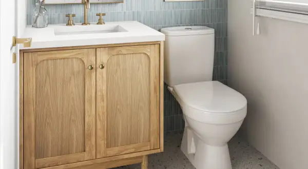 A light wood vanity with brass hardware offers a warm, inviting feel, proving it's the best vanity color for small bathrooms.
