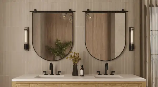 A modern bathroom vanity with two sinks, featuring oval mirrors with a subtle mirror thickness.