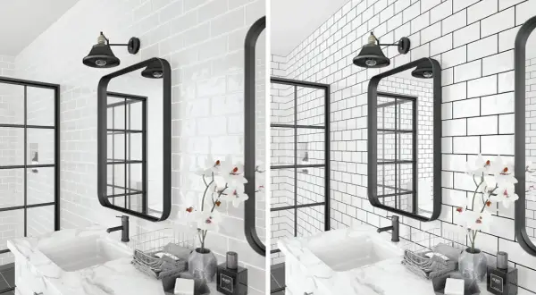 A modern bathroom features white subway tile with dark grout, a black framed mirror, and a black industrial-style light fixture.