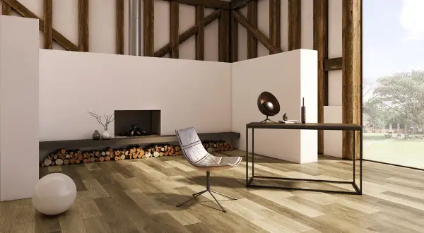 Modern living room with a fireplace, chair, and desk, featuring diverse vinyl plank layout patterns on the floor.