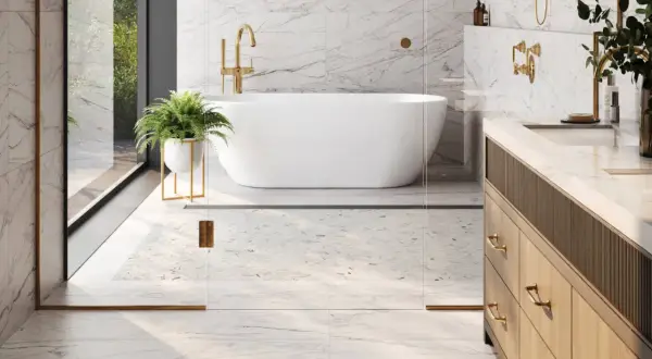 A luxurious bathroom with marble floors, a freestanding tub, and a vanity. This image shows why marble is good for bathroom floors, offering elegance and durability.