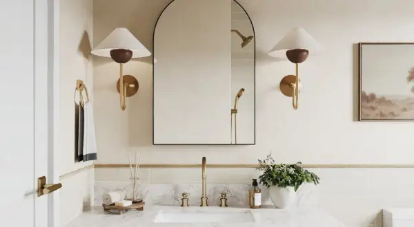 A modern bathroom with a large arched mirror above a 36-inch vanity. The mirror is framed in black and reflects a showerhead.
