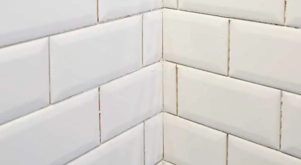 White subway tile corner with mitre cuts, showcasing clean subway tile edge options for a seamless finish.