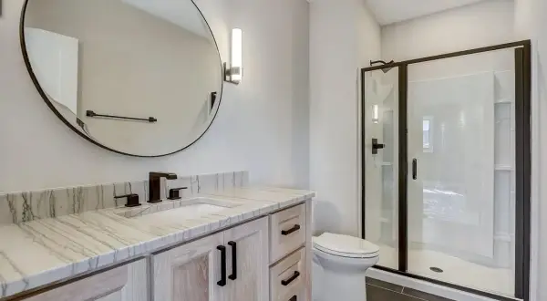 Modern bathroom with a quartzite vanity top. Learn how to clean quartzite to keep this beautiful surface sparkling.