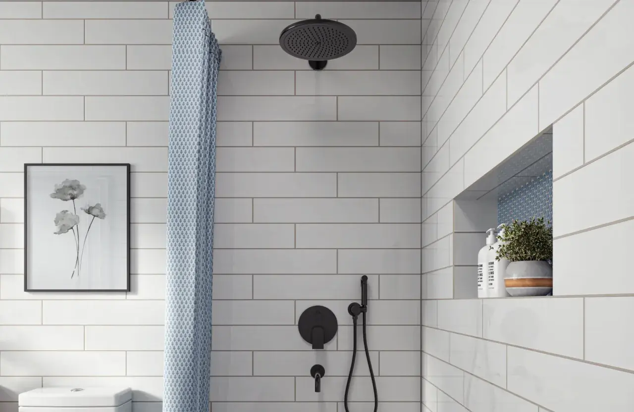 A modern bathroom features white subway tile with light gray grout, a black showerhead, and a patterned shower curtain.