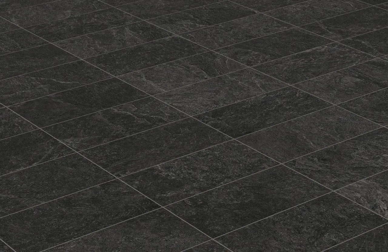 A textured, dark grey tiled floor, perfect for learning how to clean black tiles in the bathroom.