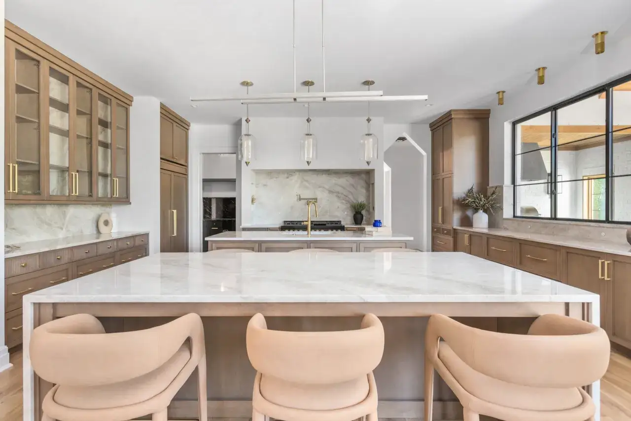 A modern kitchen with a large quartzite island and counter. Learn how to clean quartzite to keep this beautiful surface sparkling.