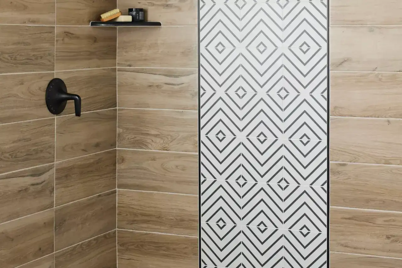 Shower floors featuring wood-look tiles and a striking geometric pattern.