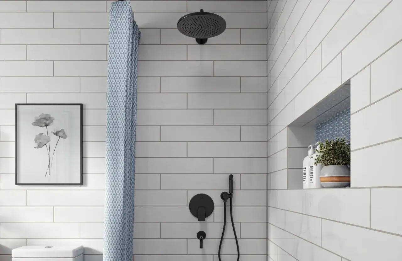 A modern bathroom features white subway tile with light gray grout, a black showerhead, and a patterned shower curtain.