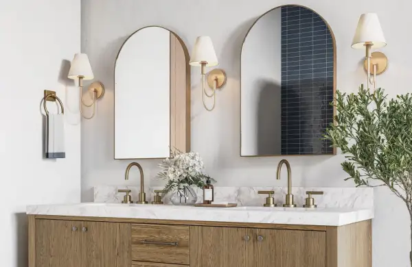 A modern double vanity with marble countertop, brass fixtures, and arched mirrors. The image hints at ideal double vanity dimensions for a spacious bathroom.