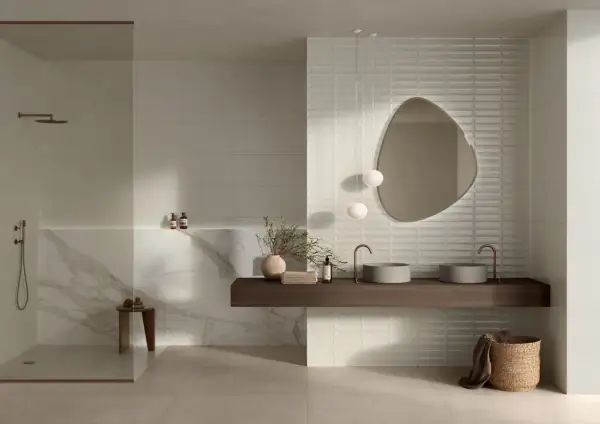 Modern bathroom featuring large format neutral tiles and textured subway tiles, showcasing diverse types of tile for bathroom design.