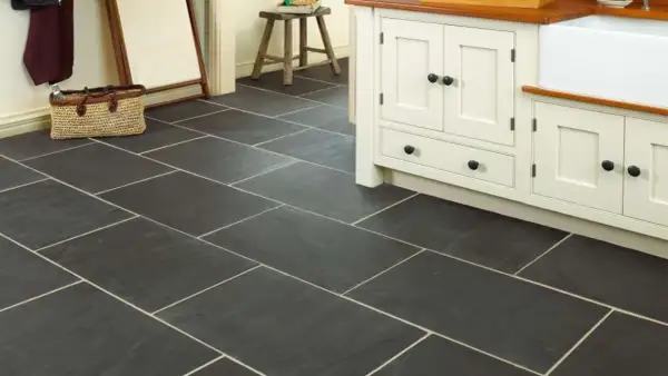 Dark slate tiles with light grout in a kitchen. Learn how to clean slate floors to keep them looking this good.