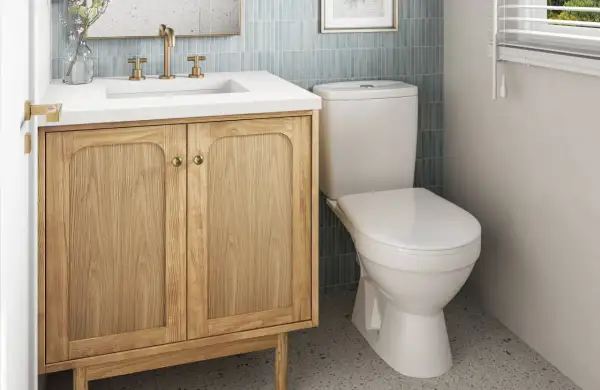 A light wood vanity with brass hardware offers a warm, inviting feel, proving it's the best vanity color for small bathrooms.
