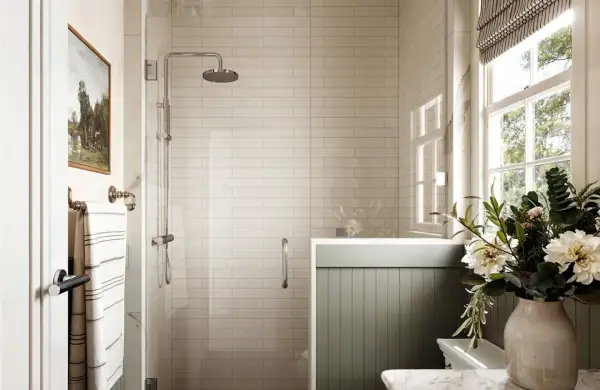 Elegant bathroom with white subway porcelain tile shower ideas, a rainfall showerhead, and a window with natural light.