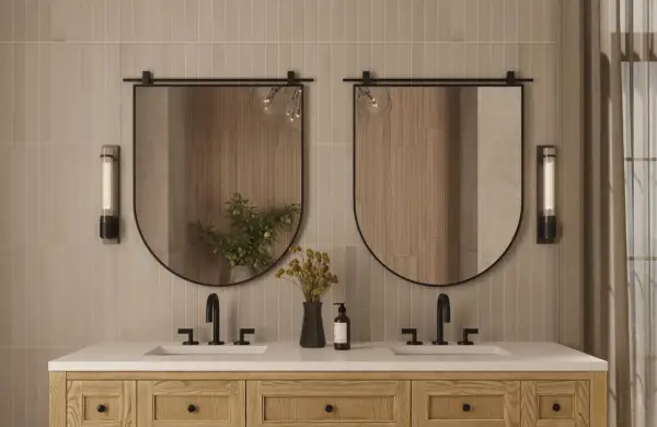 A modern bathroom vanity with two sinks, featuring oval mirrors with a subtle mirror thickness.