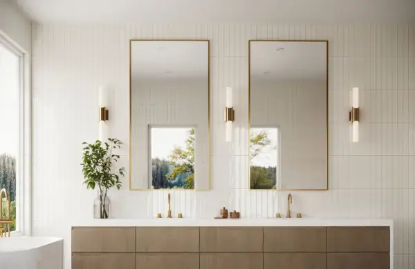 Modern bathroom with vertical subway tile design ideas, featuring a double vanity, gold-framed mirrors, and natural light.