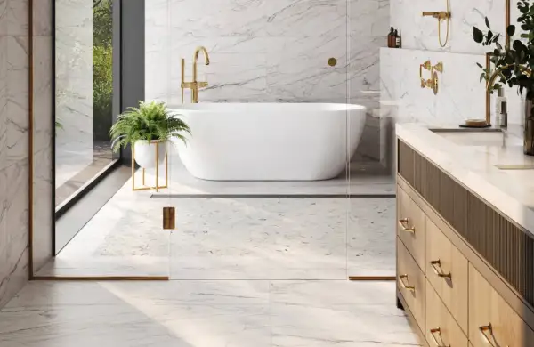 A luxurious bathroom with marble floors, a freestanding tub, and a vanity. This image shows why marble is good for bathroom floors, offering elegance and durability.