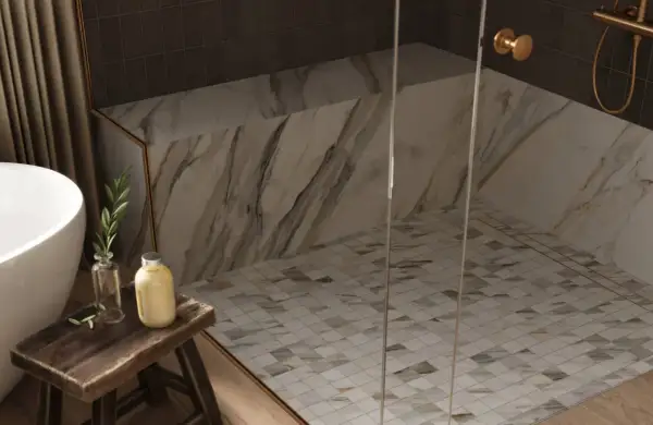 Elegant shower floors with a mosaic tile pattern, complemented by marble walls and a glass enclosure.