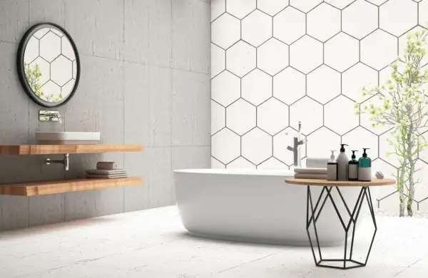 Modern bathroom with a freestanding tub, hexagonal wall tiles, and light-colored floor tiles. Ceramic tile is good for bathroom floors, offering durability and style.